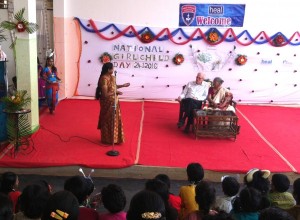 Head teacher Jyothi introduces guests on to the stage