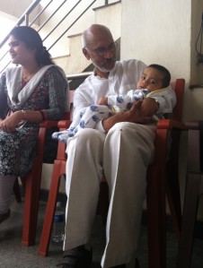 Bhavana's camera captures a tender moment as HEAL founder Dr Satya Prasad Konery holds a baby in the audience